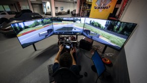 An image of someone playing a racing game with a simulator.