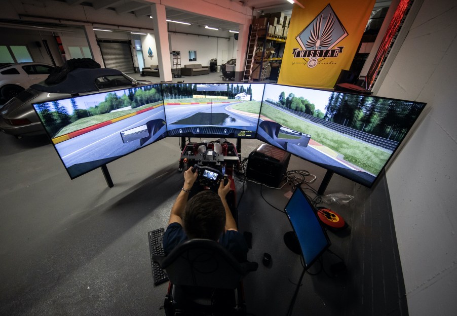 An image of someone playing a racing game with a simulator.