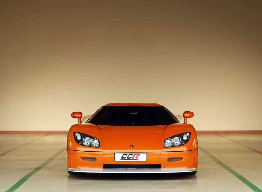 A photo of a 2004 Koenigsegg CCR at an airplane hangar.