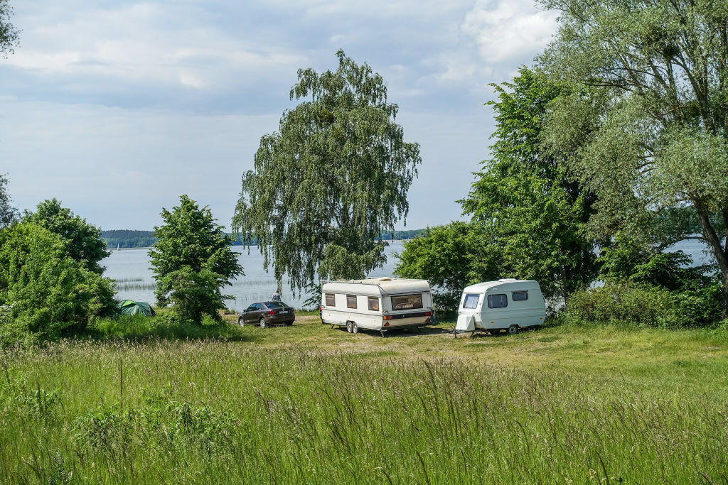 An RV is parked near a lake