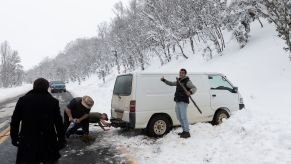 Rescuing a car from the snow after spinning it off a winter road