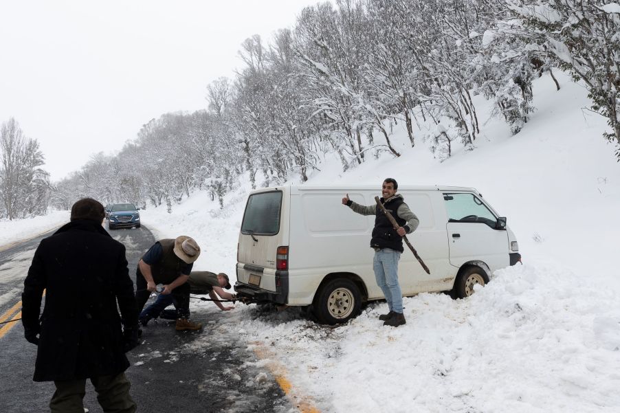 Rescuing a car from the snow after spinning it off a winter road