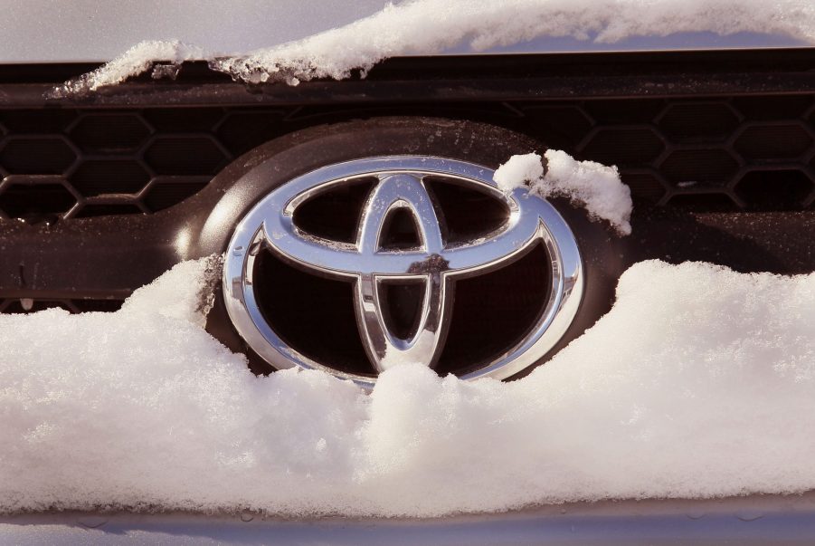 A Toyota logo seen on a snow covered SUV