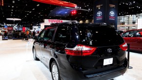 A black Toyota Sienna on display at an auto show