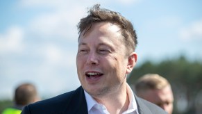 Tesla head Elon Musk talks to the press as he arrives to to have a look at the construction site of the new Tesla Gigafactory near Berlin on September 03, 2020, near Gruenheide, Germany.