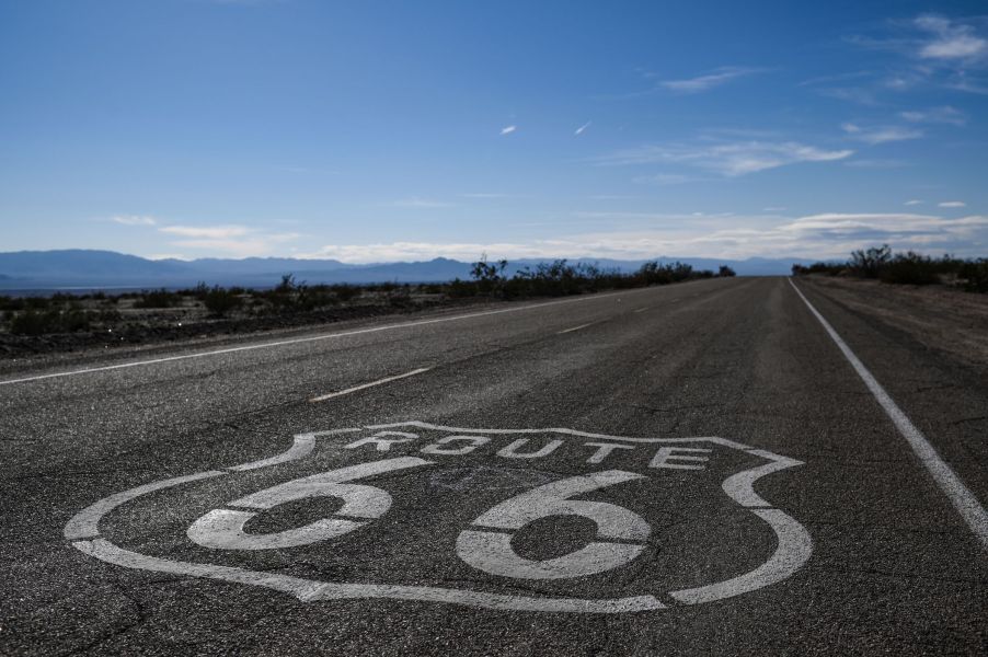 A "Route 66" sign is painted on the asphalt near Amboy in the Mojave Desert in California