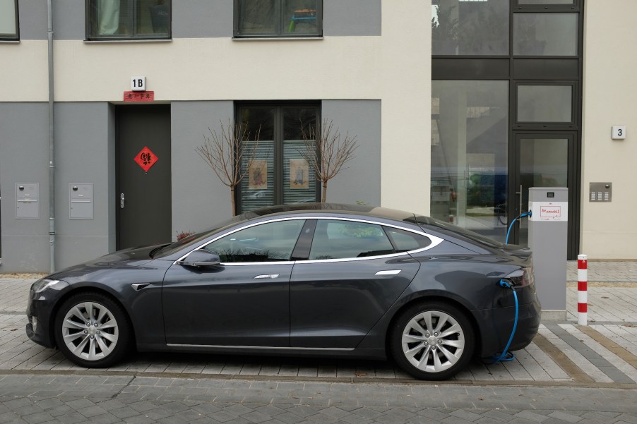 A Tesla Model S electric car charges at a public charging column on March 2, 2019, in Berlin, Germany.