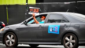 App-based drivers from Uber and Lyft protest in a caravan in front of City Hall in Los Angeles on October 22, 2020.