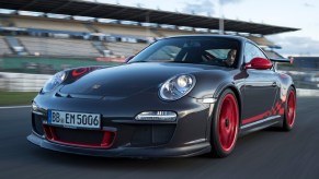 A gray 2010 Porsche 911 GT3 RS on a track