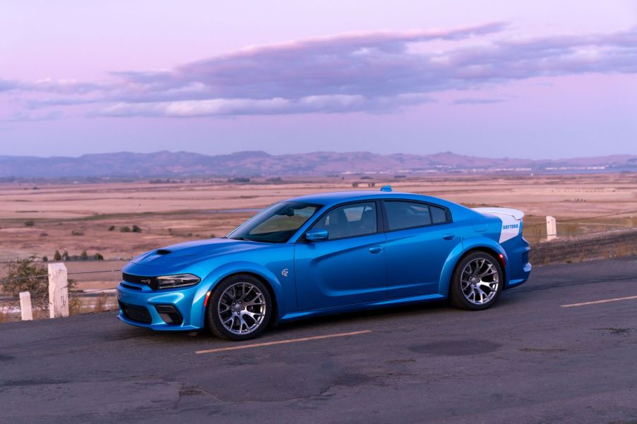 The side view of a blue-and-white 2020 Dodge Charger SRT Hellcat Widebody Daytona 50th Anniversary Edition