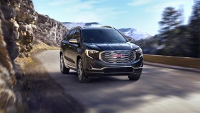 A black 2020 GMC Terrain Denali driving down a road