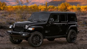 A black 2020 Jeep Wrangler SUV goes off-road.