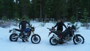 A blue 2020 Triumph Scrambler 1200 XE next to a black 2020 Honda Africa Twin