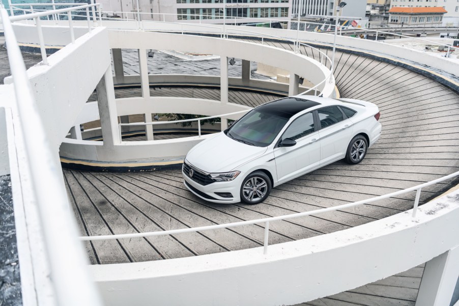 A white 2020 Volkswagen Jetta driving down a ramp