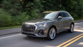 A grey 2021 Audi Q3 driving down a highway road