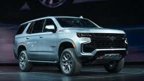 A light-blue 2021 Chevy Tahoe sits parked on a black stage.