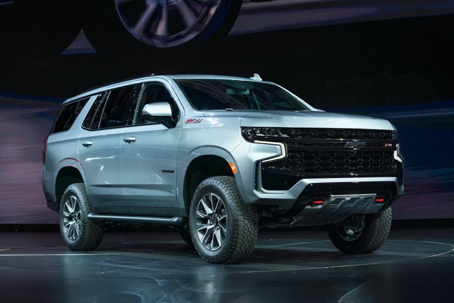 A light-blue 2021 Chevy Tahoe sits parked on a black stage.