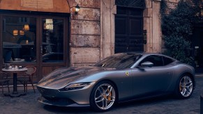 A gray 2021 Ferrari Roma by an Italian cafe