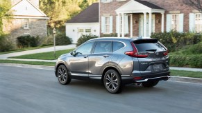 A grey 2021 Honda CR-V driving down a road