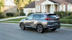 2021 Honda CR-V Touring driving in a neighborhood