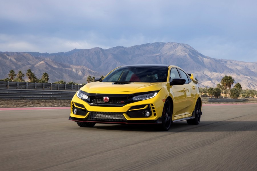 A yellow 2021 Honda Civic Type R Limited Edition driving in front of mountains