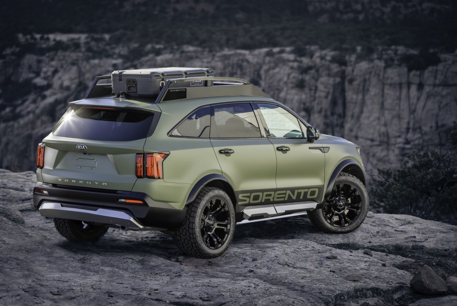 An olive-green 2021 Kia Sorento Yosemite overlooks a canyon on mountainous terrain