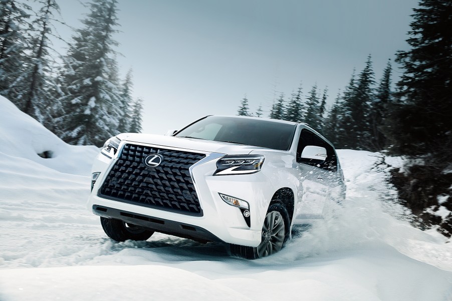 A white 2021 Lexus GX full-size SUV drives through the snow