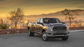 A 2021 Ram 3500 parked on display with trees in the background