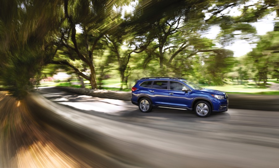 A blue 2021 Subaru Ascent driving down a road