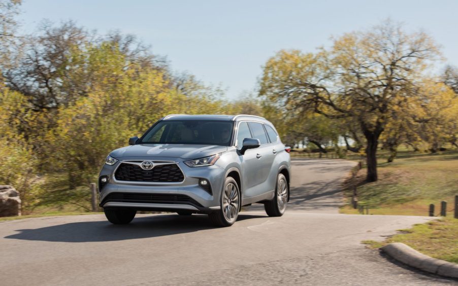 A silver 2021 Toyota Highlander parked between two trees