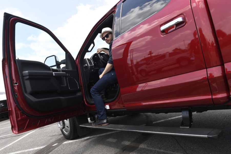 A man stepping out of his Ford F-450 pickup truck