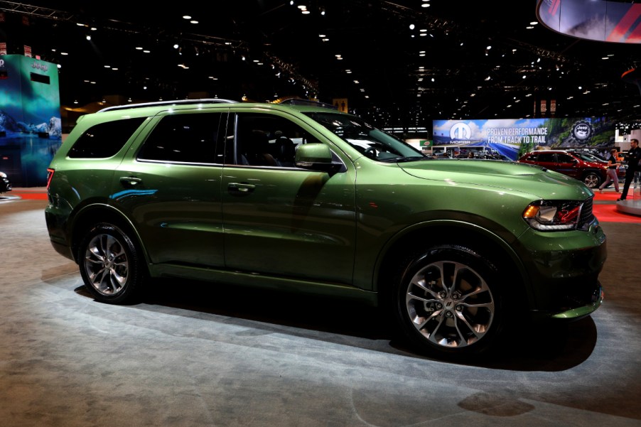 A green Dodge Durango on display at an auto show