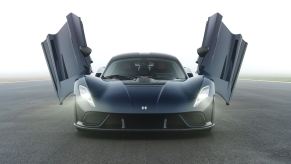 A view head-on of the Hennessey Venom F5 hypercar with its butterfly doors open.