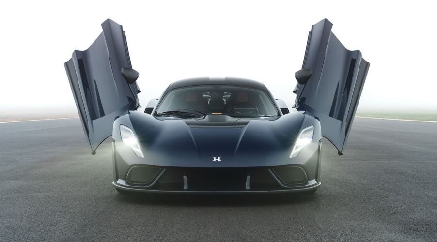 A view head-on of the Hennessey Venom F5 hypercar with its butterfly doors open.