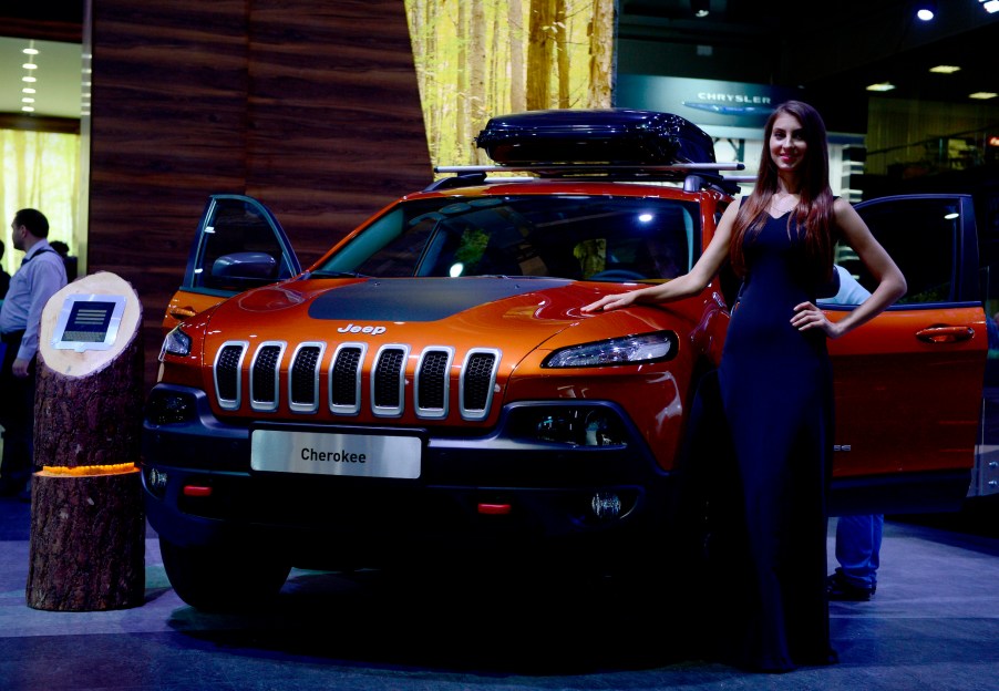 A model poses next to Cherokee model of Jeep during the Moscow International Motor Show 'Autosalon 2014