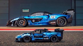 A blue Lego McLaren Senna GTR in front of a real blue McLaren Senna GTR