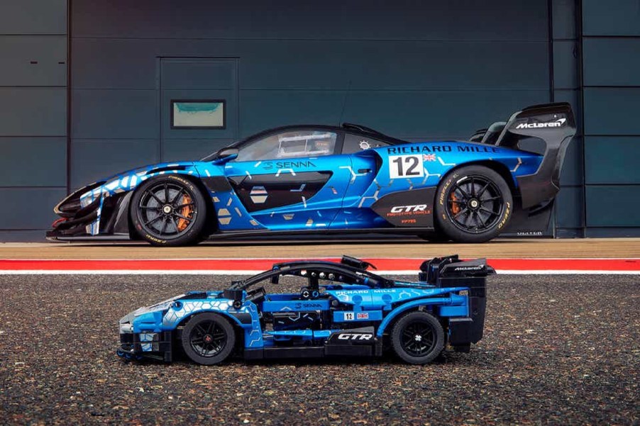 A blue Lego McLaren Senna GTR in front of a real blue McLaren Senna GTR