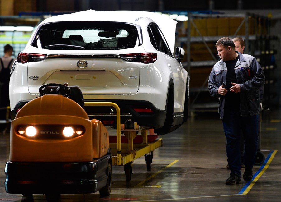 A Mazda CX-9 being assembled in a factory