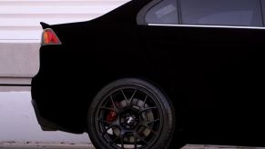 The rear of a Mitsubishi Evo painted in Musou Black