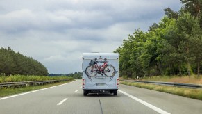 An RV driving down a scenic road