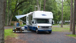 Woman preparing meal outside motorhome