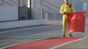 Race Marshall holds a red flag on the racetrack