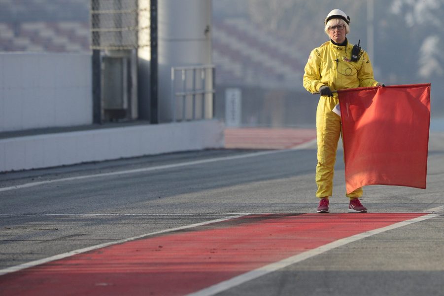 Race Marshall holds a red flag on the racetrack