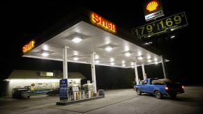 A pickup truck pulling into a gas station to fuel up