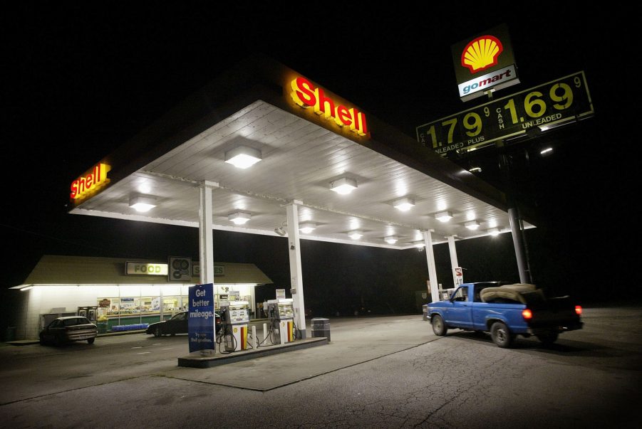 A pickup truck pulling into a gas station to fuel up