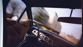 Blurred oncoming truck seen through windshield of car on U.S. 20 in western Illinois.