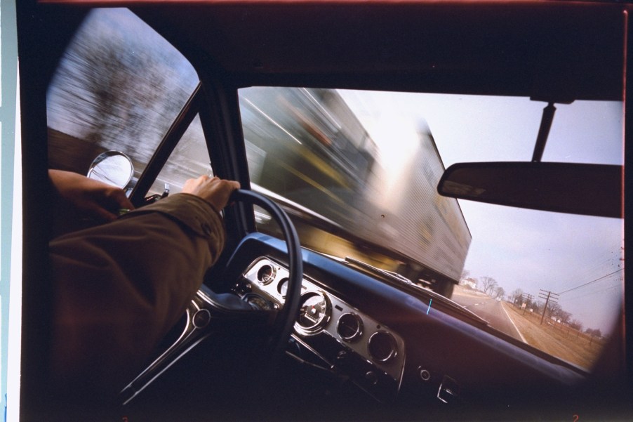 Blurred oncoming truck seen through windshield of car on U.S. 20 in western Illinois.