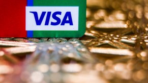 Visa logo is seen on a credit card in this illustration