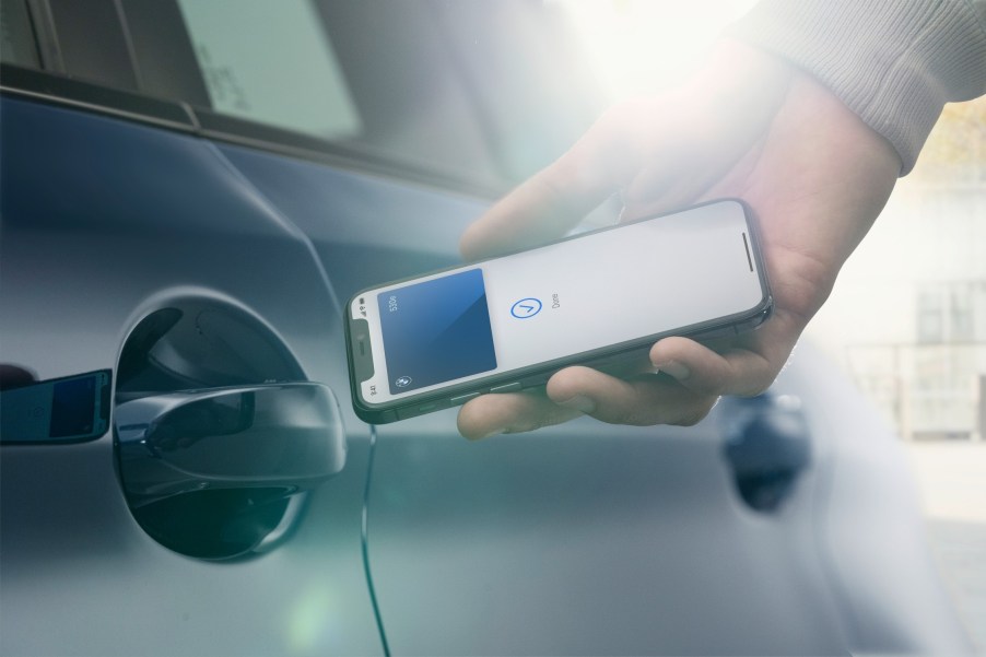 BMW Digital Key app being held up to the driver door handle | BMW