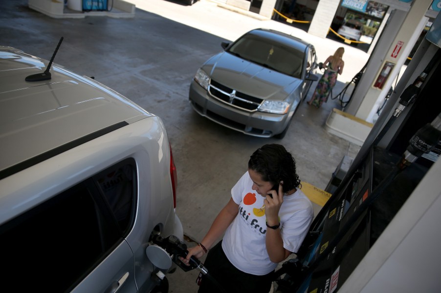 A woman talks on a cell phone at a gas station in Pembroke Pines, Florida, in April 2014.